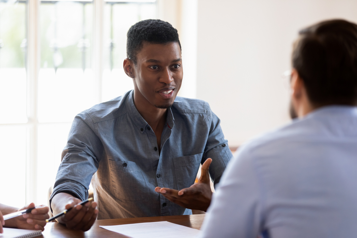 Business meeting process, African ethnicity skilled briefing participant manager express opinion share thoughts offers solution to problem during negotiations with clients company customers in office