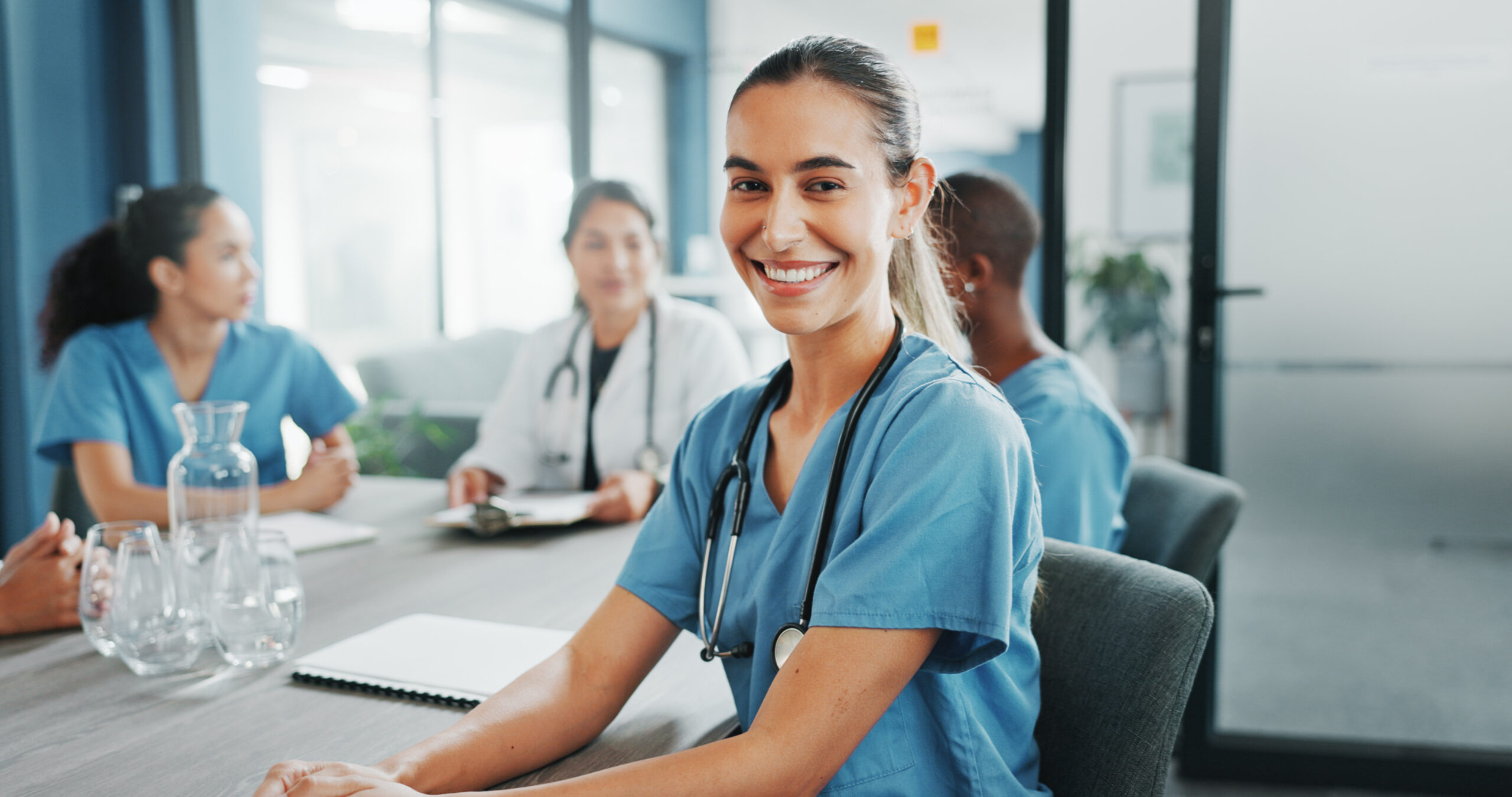 Woman, face or nurse in hospital meeting for medical planning, life insurance medicine or treatment training. Smile, happy or healthcare worker portrait in teamwork, collaboration or clinic diversity.